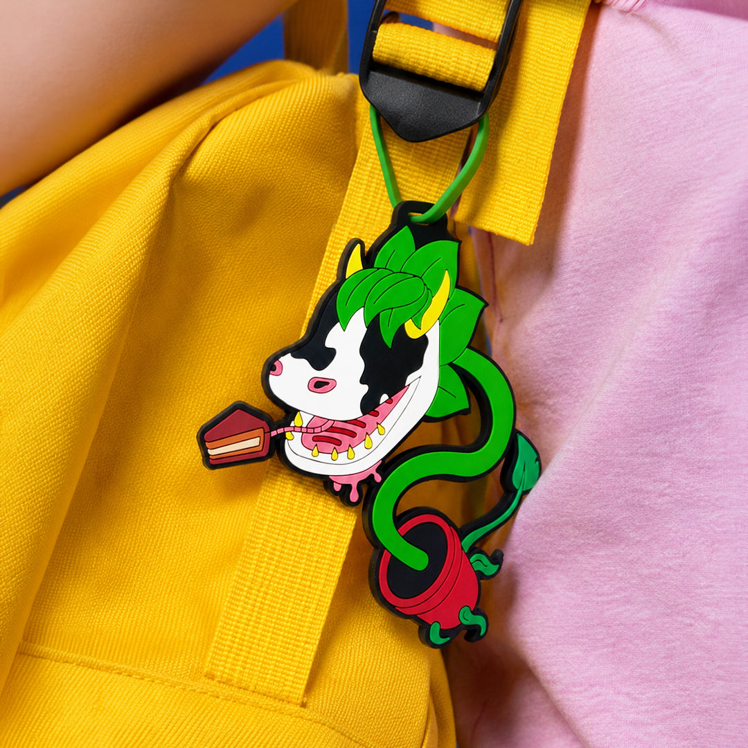 Colorful cartoon character keychain attached to a yellow bag