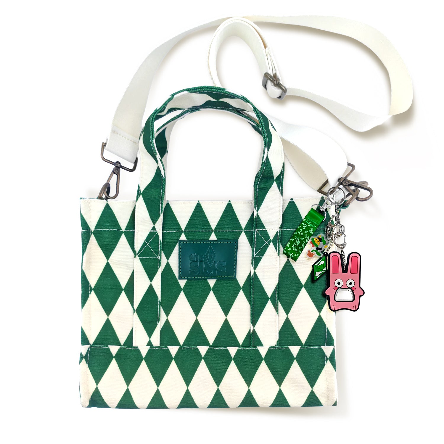 Green and white patterned bag with a pink charm on a white background