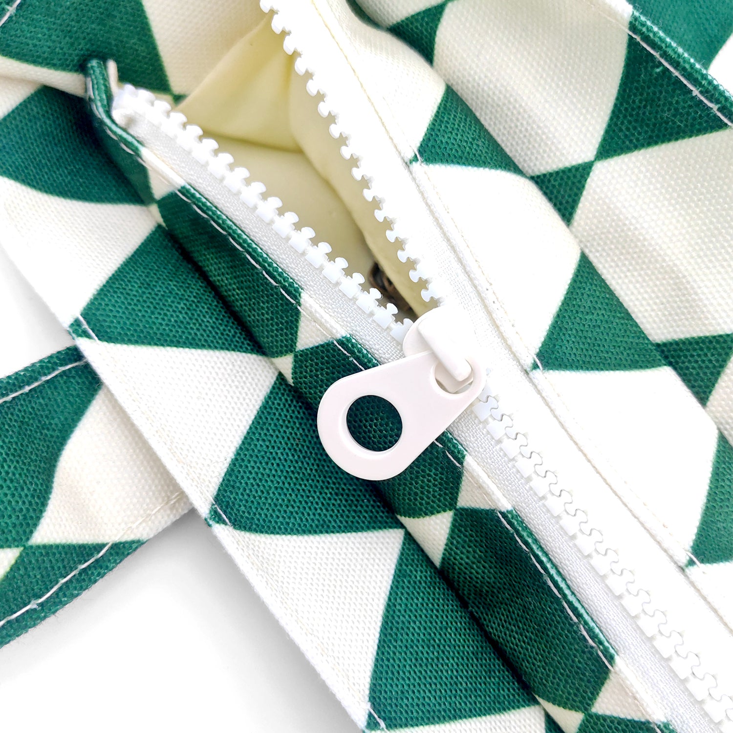 Green and white checkered fabric with a zipper