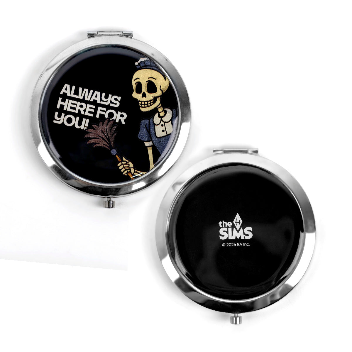 Two round compact mirrors with silver metal edges on a white background. One compact is open, showing a black interior with a cartoon skeleton wearing a nurse hat and the text 'ALWAYS HERE FOR YOU!'.