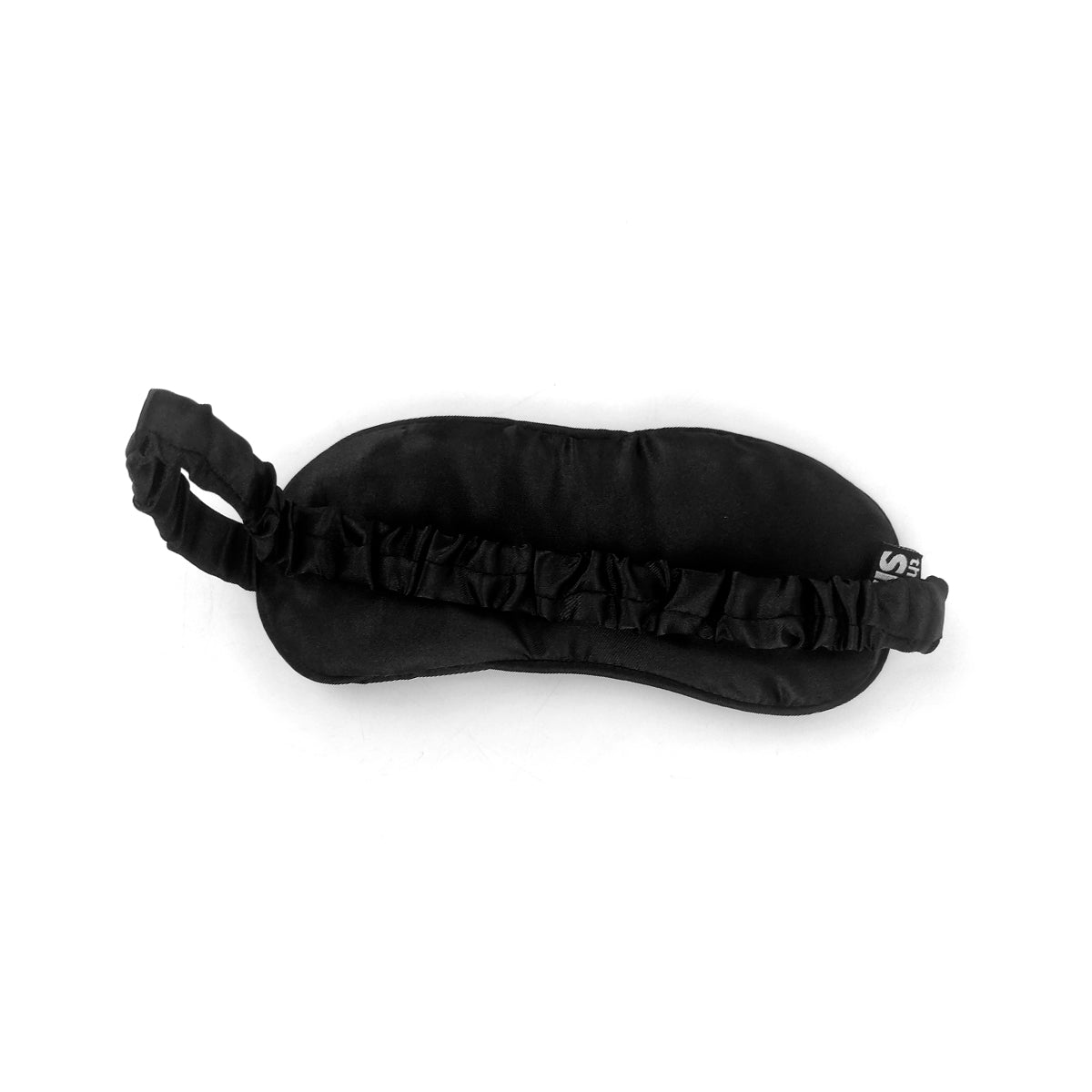 A black eye mask with a gathered elastic strap and a small white logo on the side, shown on a plain white background.