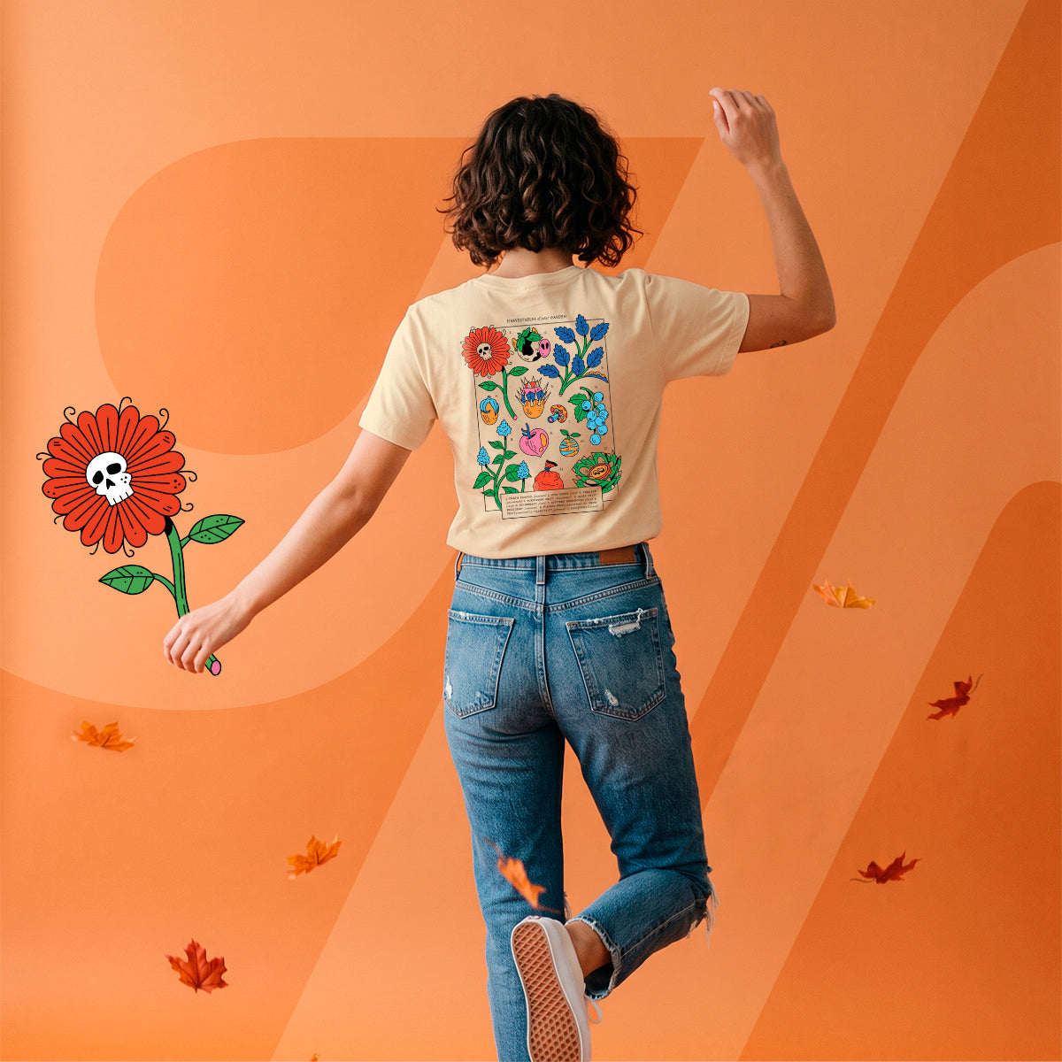 A person shown from behind wearing a beige graphic T-shirt and blue jeans, standing against a bright orange background with stylized paper leaves and a large flower illustration.
