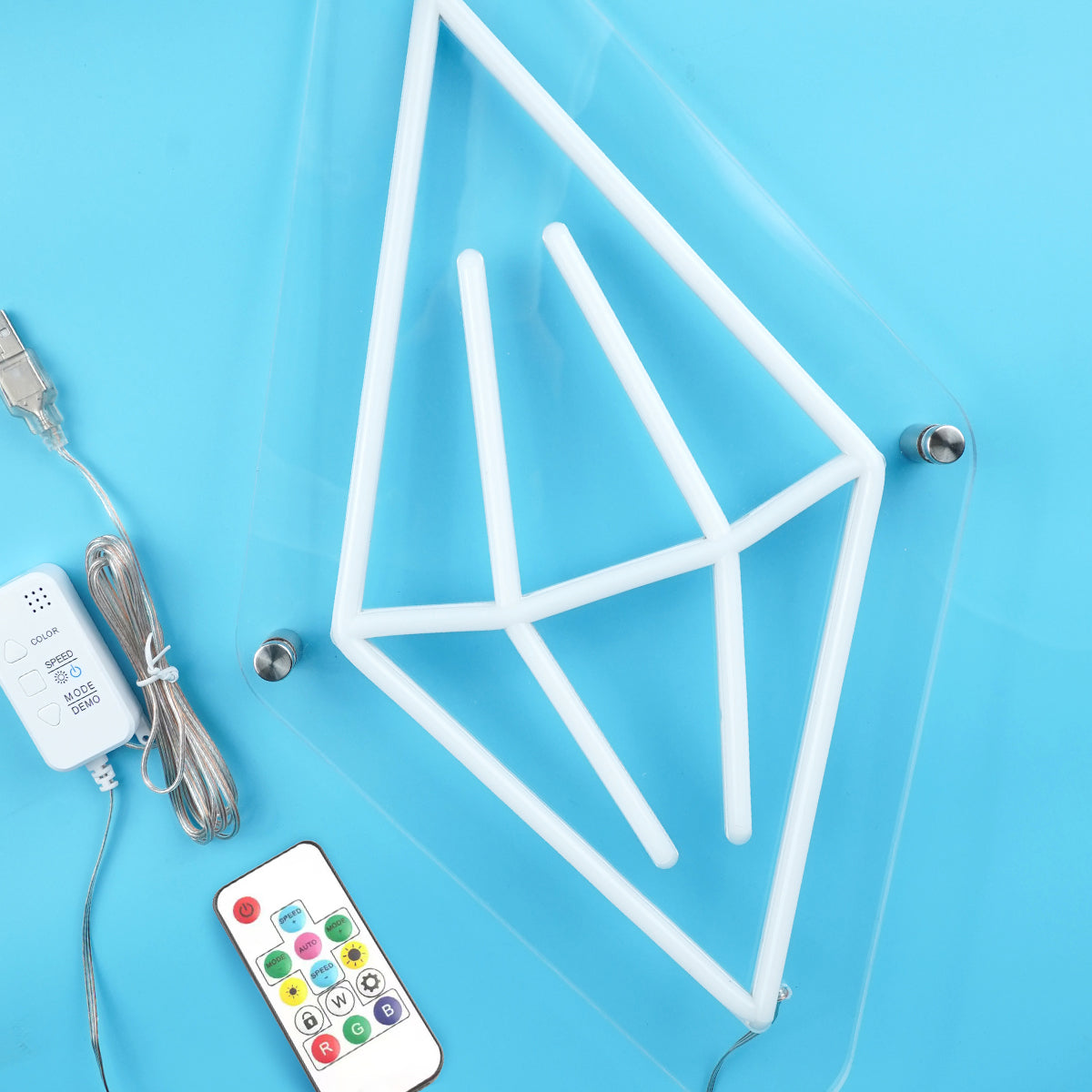 Geometric LED light frame with remote control and power adapter on a blue background