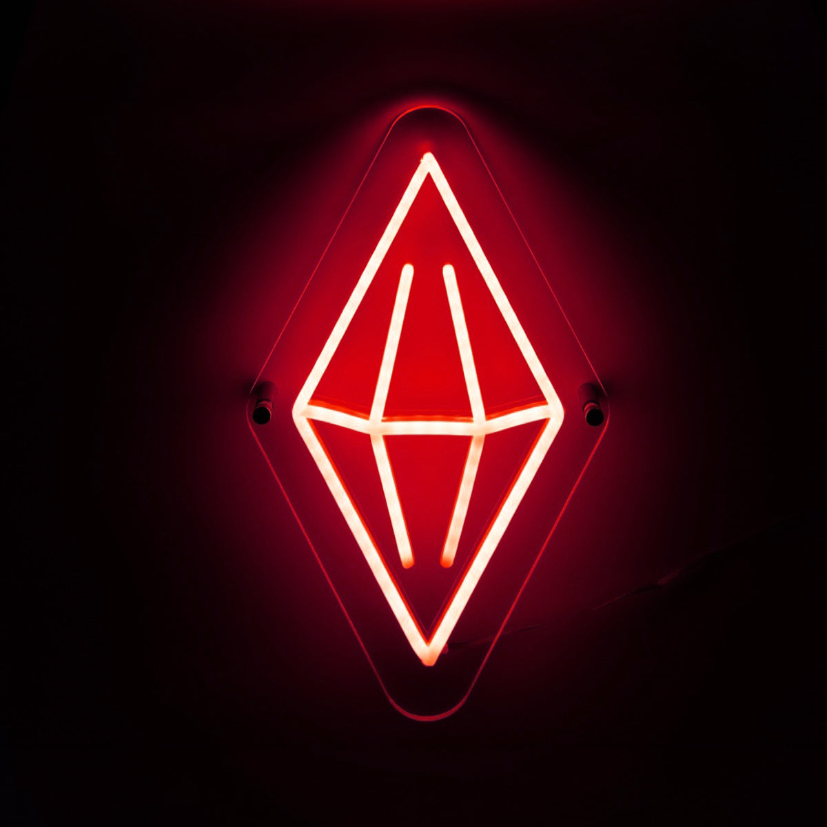 Neon sign with a geometric red design on a black background